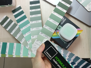 the imagiCharm and its packaging surrounded by pantone color palettes
